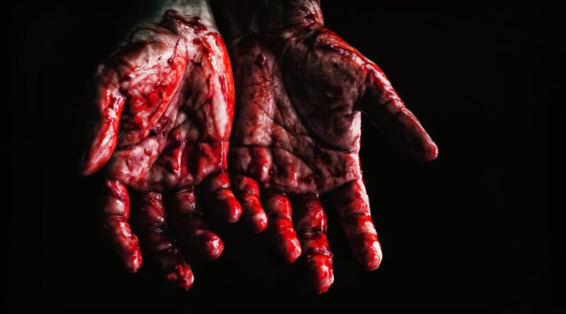 person s hands covered with blood
