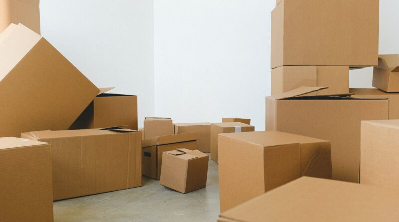 pile of cardboard boxes scattered on floor during relocation