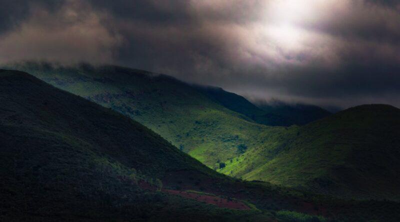 green mountains under dark sky