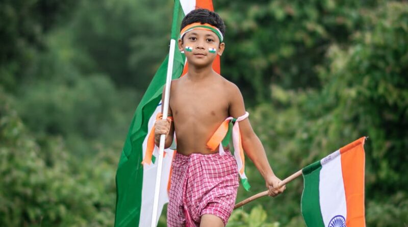 kid holding two indian flags
