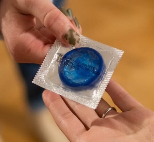 handing out blue condom