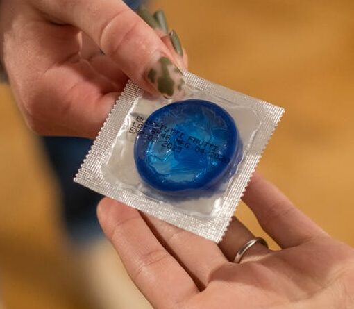 handing out blue condom