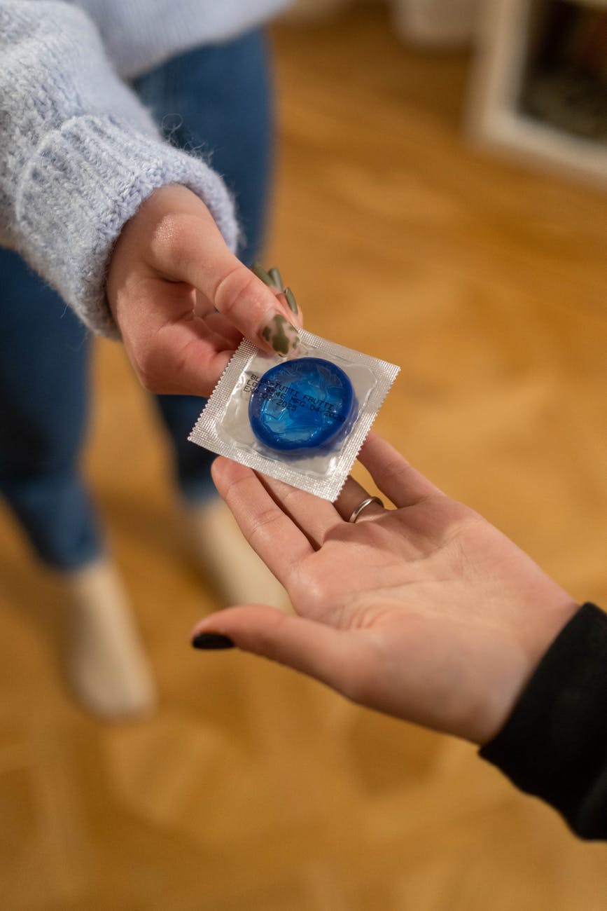 handing out blue condom