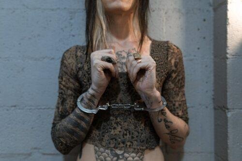 a woman with tattoo with handcuffs