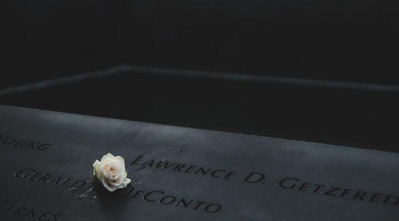 a rose flower over memorial marker