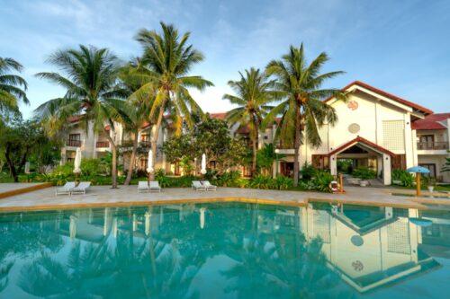 white and brown concrete villas near swimming pool