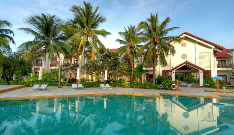 white and brown concrete villas near swimming pool