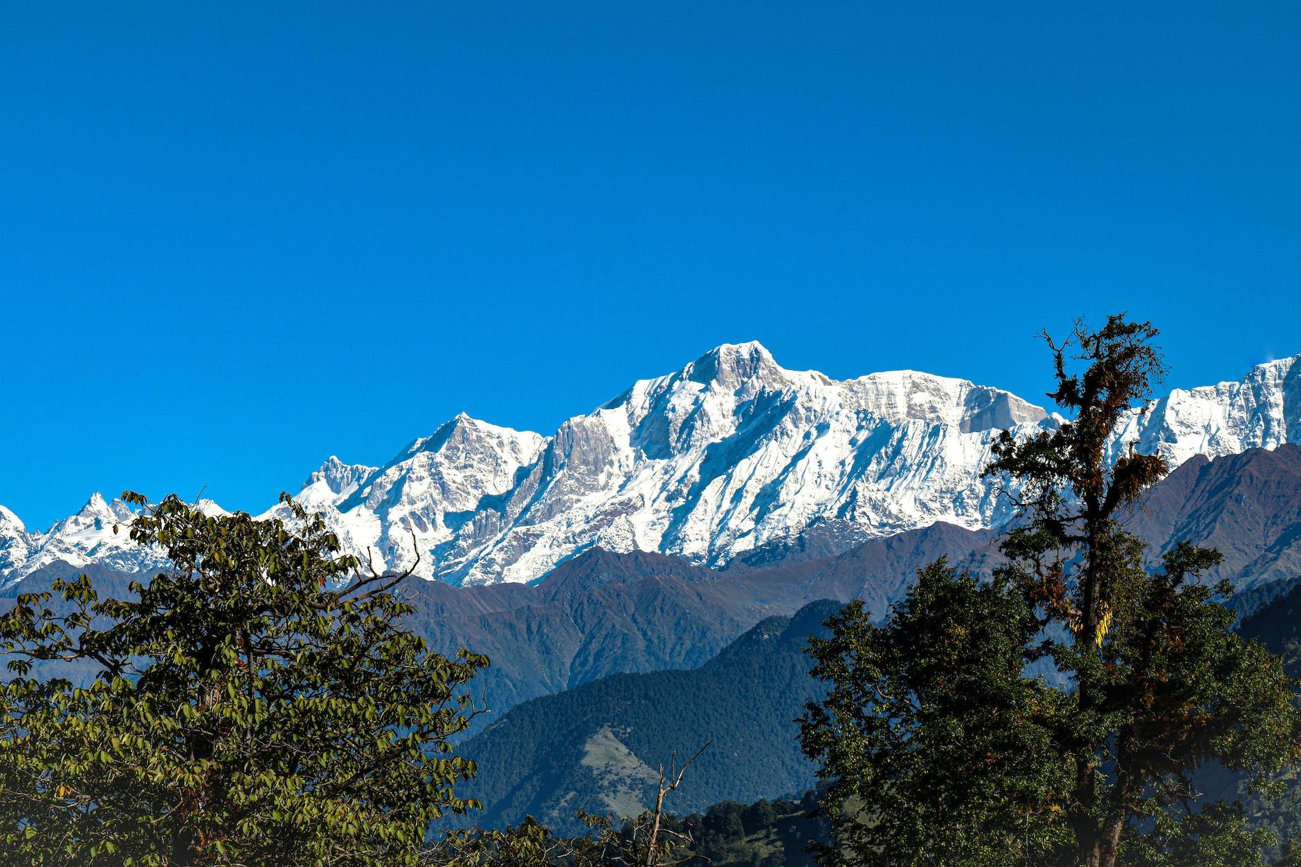 a mountain with snow under the blue sky