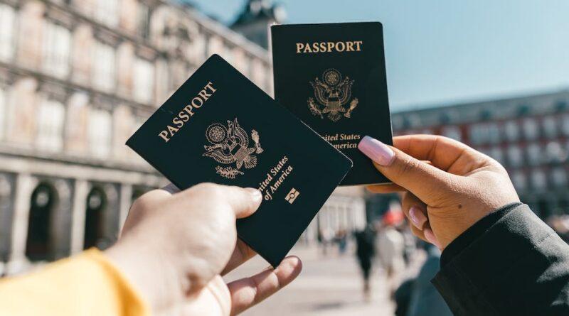 anonymous tourists showing us passports on street on sunny day